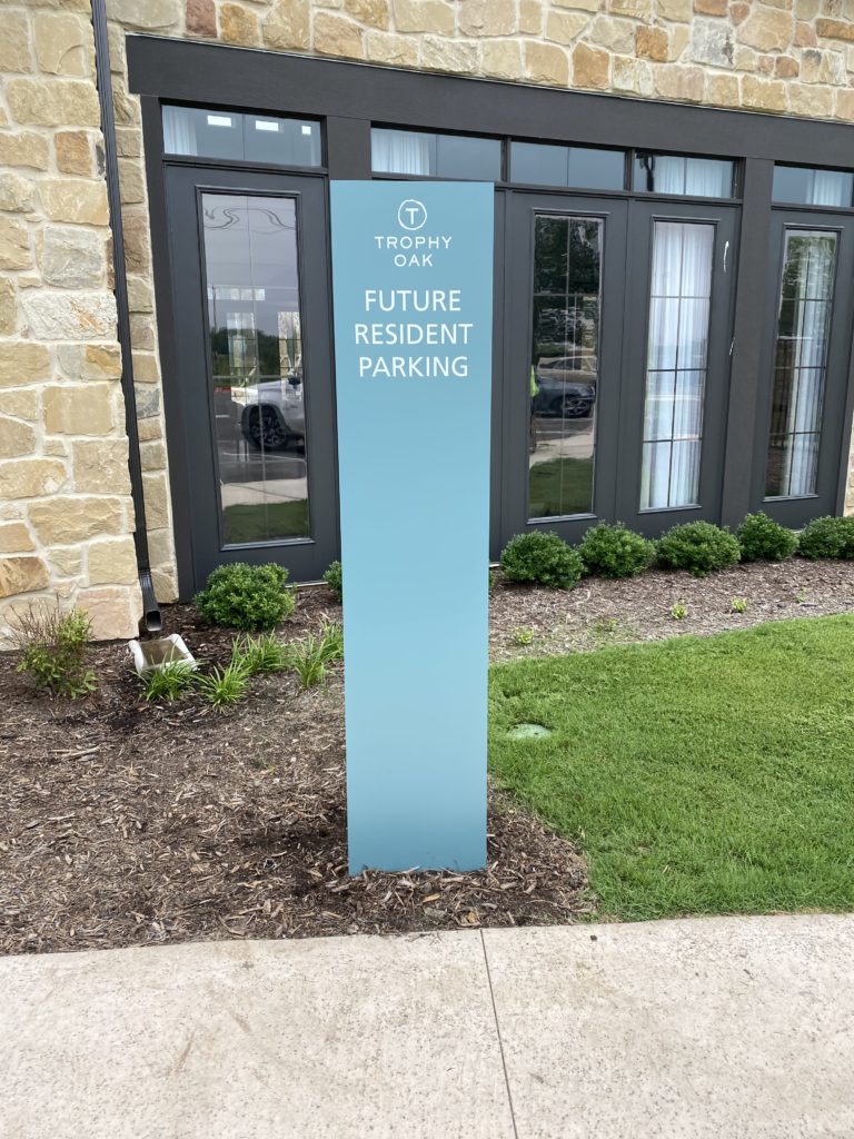 Future resident parking sign outside building.