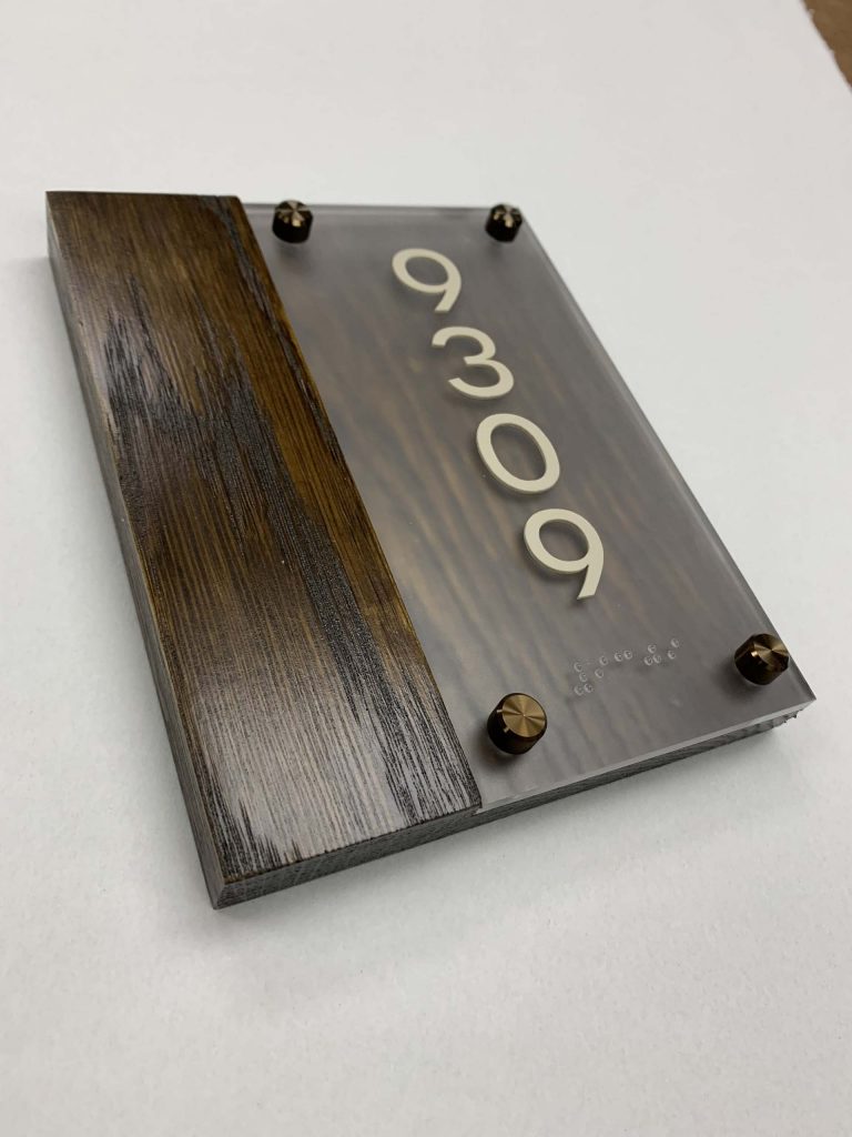 Modern room number 9309 sign with Braille.