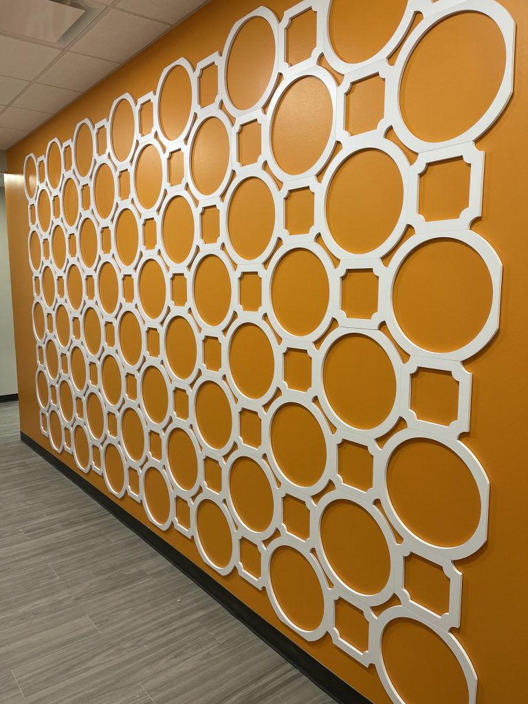 Orange wall with circular white pattern design.