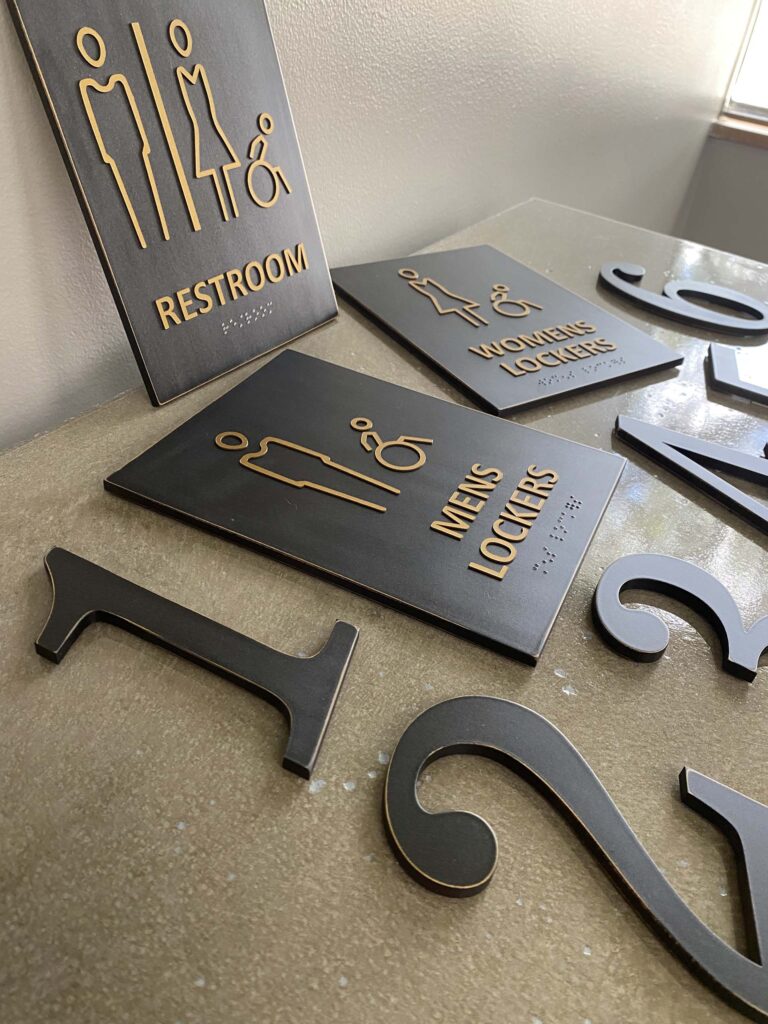 Braille restroom signs on a table